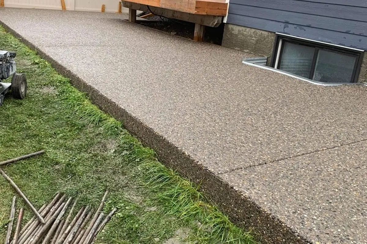 Backyard exposed aggregate concrete patio built in Calgary