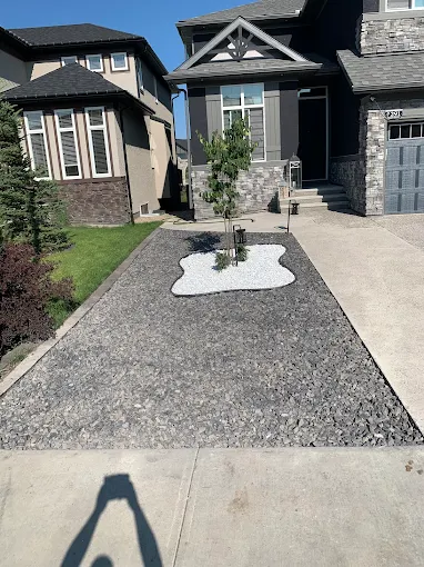 Rock bed + concrete island in Calgary — AACWORKX Concrete & Landscaping