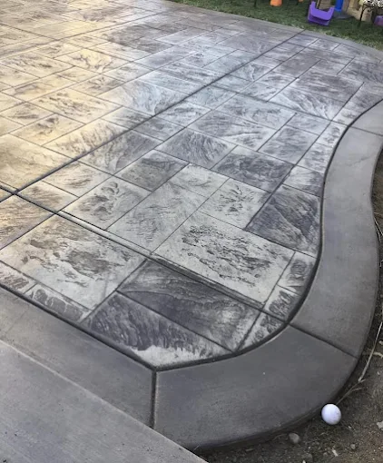 Stamped ashlar border (curved) in Calgary — AACWORKX Concrete & Landscaping